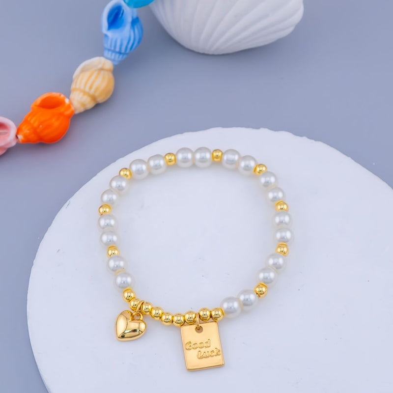 Pulsera elastica con perlas, bolitas y colgantes baño 18k