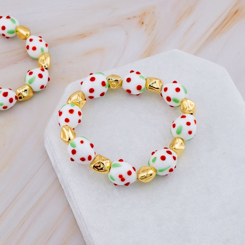 Pulsera elastica de fresa en resina y separadores en baño 18k