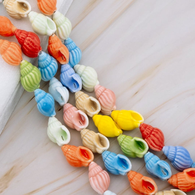 Piedra ceramica en forma de caracol de mar multicolor